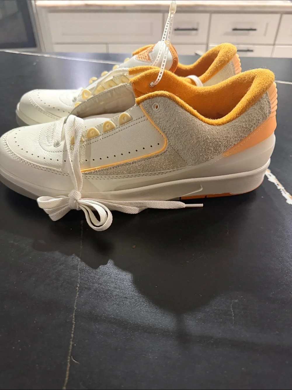 Jordan White and Orange Low-Top Sneakers with Gold Logo Accent